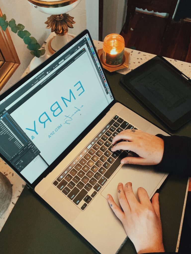 Bliss and Tell Creative - Bekah working on brand design in studio on computer.